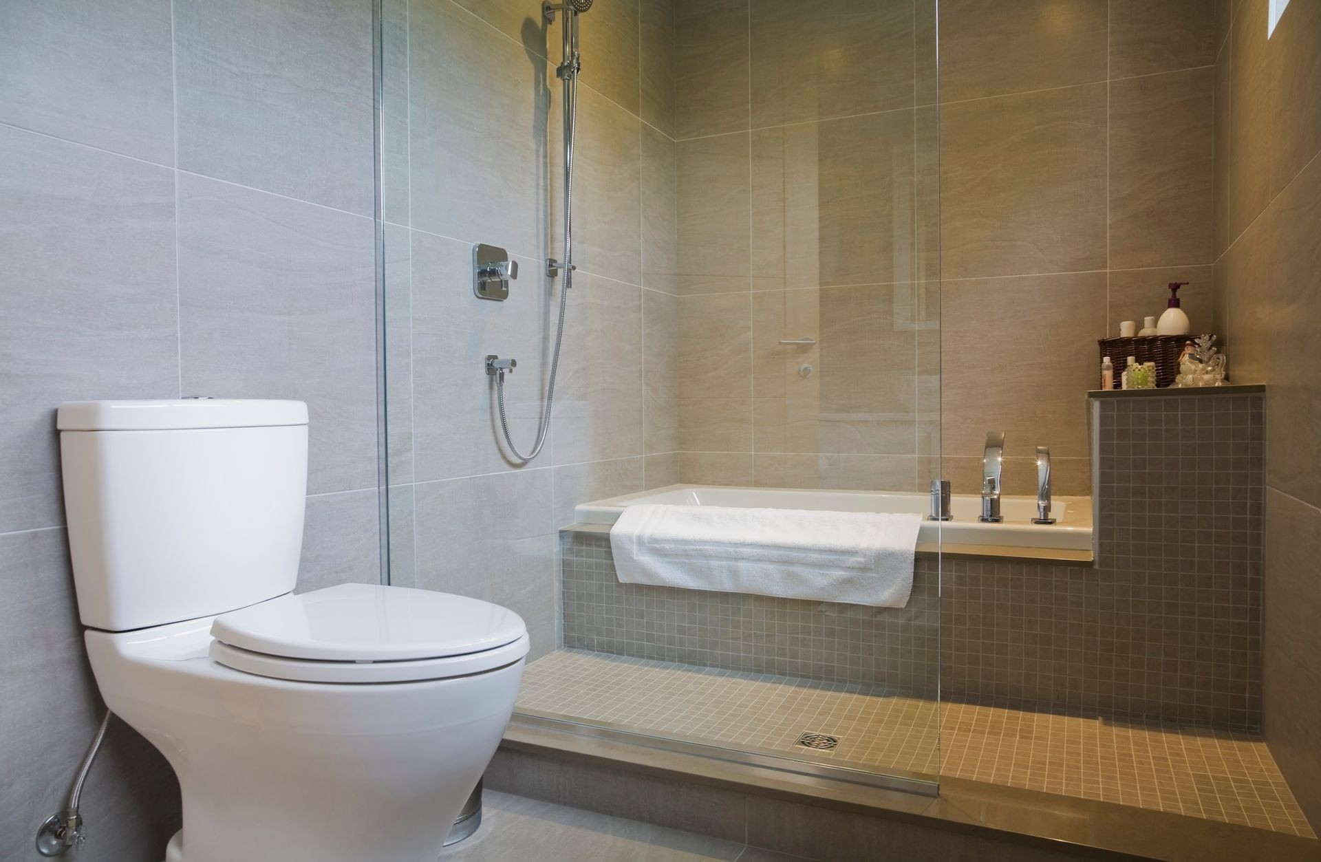 Modern bathroom with bath tub, toilet and glass shower screen